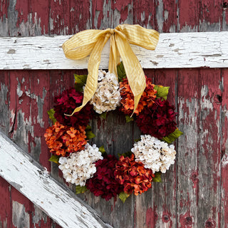 Adding a bow to a wreath, hanging a wreath with a bow