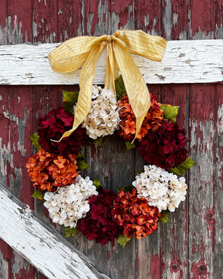 Adding a bow to a wreath, hanging a wreath with a bow