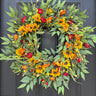 Decorative wreath with autumnal flowers on a door