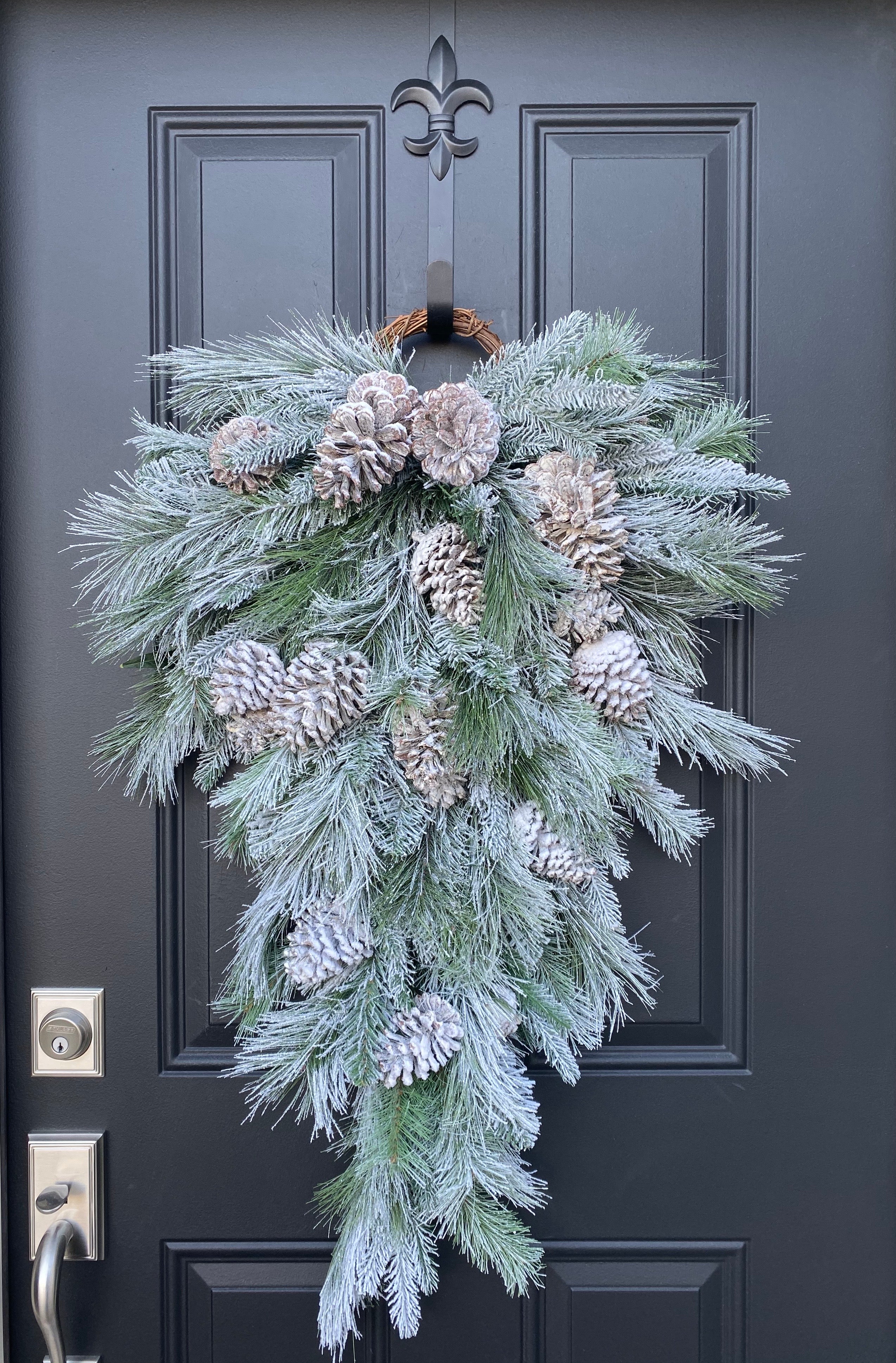 Welcome this winter season with this classic pine cone door swag! Made with  3 JUMBO pine …